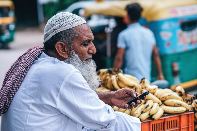 mature adult, city, ethnic, street market, healthy eating, common, black, food, trade, cart, work, simple, multicolored, bright, phone, man, men, farmers market