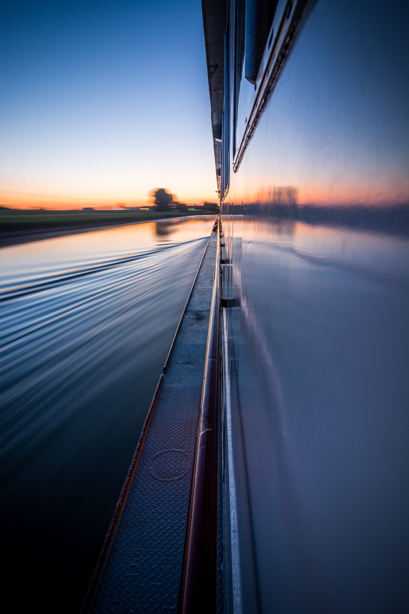 brown, cue, no people, diminishing perspective, sea, mode of transportation, wooden, transportation, dawn, blurred motion, nature, speed, dusk, orange color