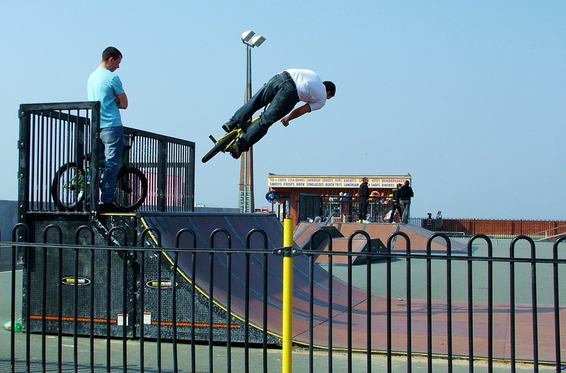 youth, clear sky, sport, barrier, one person, silhouette, cycle, fence, speed, occupation, casual clothing, mountain, trick, danger, bike, downhill, cycling