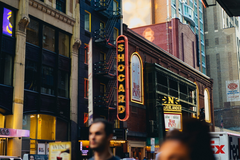 urban, architecture, theater, real people, walking, shop, built structure, beside, building exterior, downtown, city, hotel, street, along, daytime, incidental people