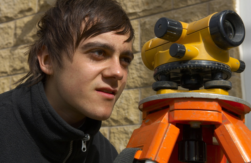 real people, engineer, portrait, smiling, one person, levels, looking at camera, outdoors, occupation, happiness, adult, looking, young adult, males, surveyor