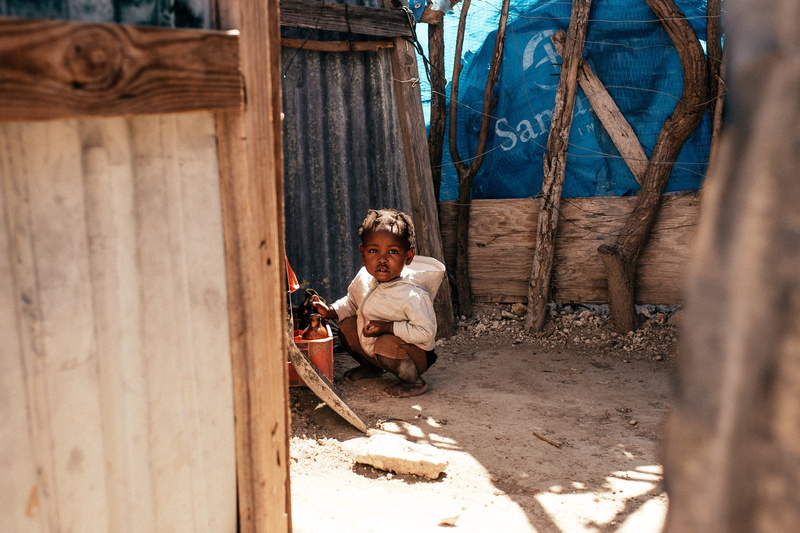 adult, person, one person, smiling, emotion, lifestyles, building, galvanized, day, childhood, outdoors, shack, child, lonely, clothing, sheet, nature