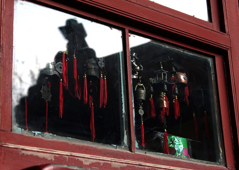 reflection, outdoors, building exterior, window, close-up, shop, city, day, 2K, no people, merchandise, architecture, red, transparent, brass bells, telephone booth