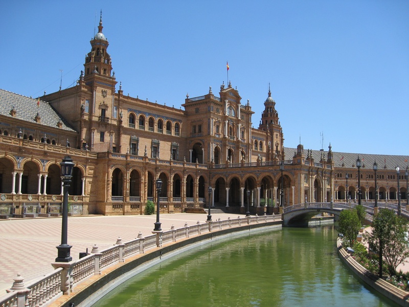 arch, travel destinations, plaza de espania, city, tourism, architecture, history, outdoors, government, no people, daytime, andalucia, the past, water