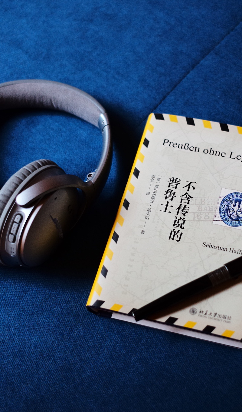 cordless, text, close-up, couch, high angle view, beside, travel, preparation, blue, western script, book, textile, headphones, no people, indoors, table