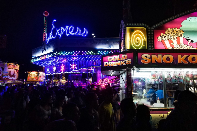 corn dog, cne, popcorn, spectator, family, festival, western script, ex, group of people, corndog, hotdog, real people, outdoor, attraction, county, built structure