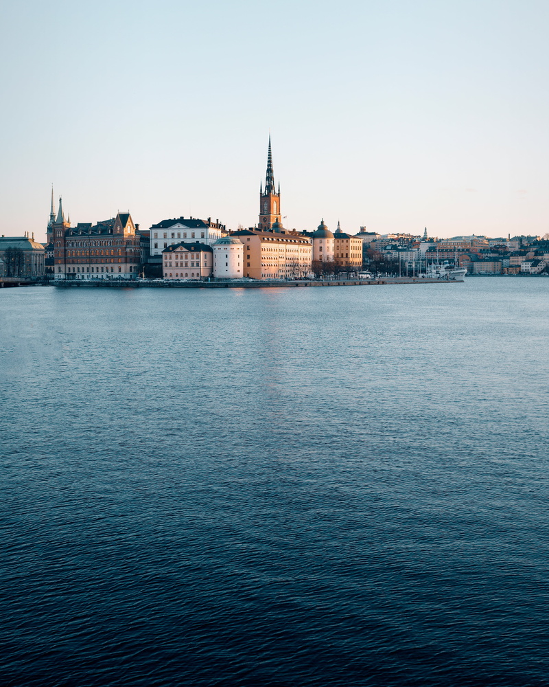 waterfront, infrastructure, travel destinations, water, tower, urban, gray, spire, built structure, clear sky, sea, establishment, urban skyline, ocean