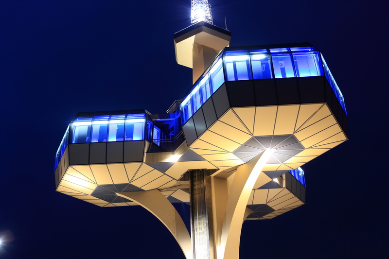 outdoors, tower, illumination, lighting equipment, low angle view, building exterior, sign, modern, arts culture and entertainment, transmission, evening