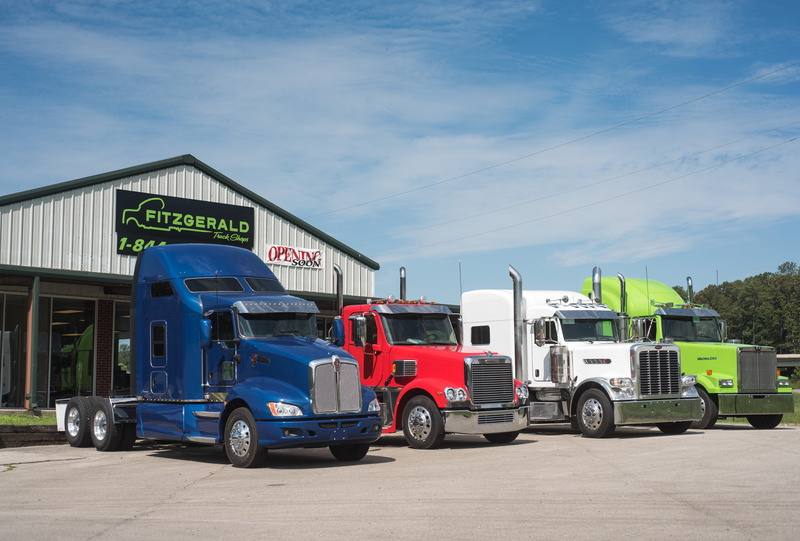text, communication, sky, blue, truck, outdoors, day, commercial land vehicle, land vehicle, business, motor vehicle, transportation, sunlight, building exterior