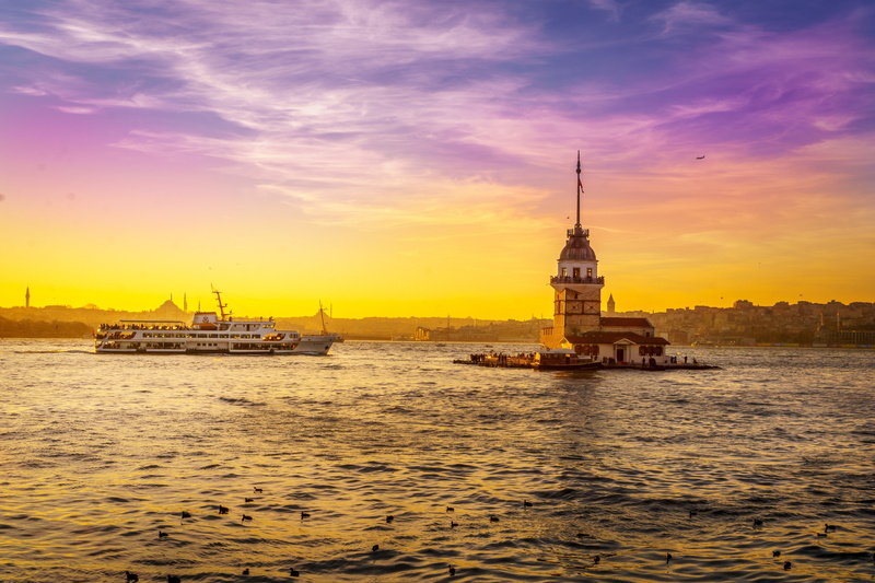 sea, waterfront, transportation, tourism, istanbul, travel destinations, sky, cloud - sky, the past, sunset, turkey, water, tower, city, spire, nautical vessel