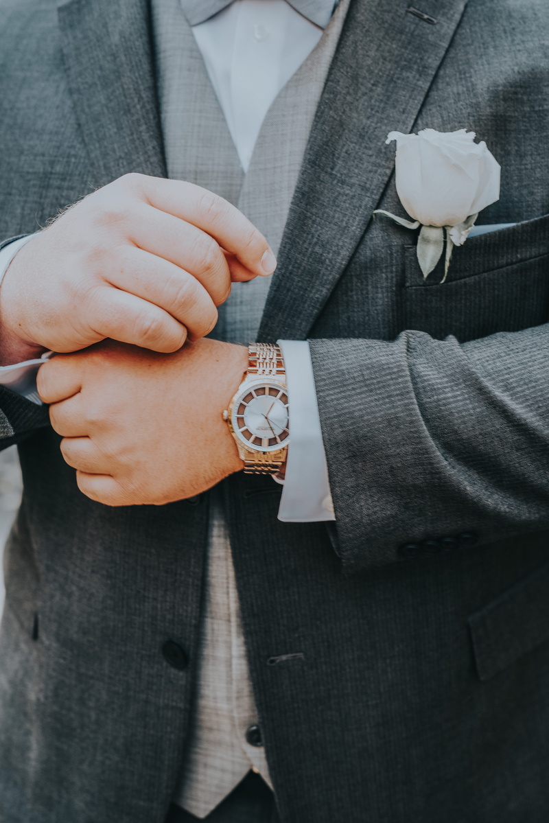 real people, men, white, human body part, wearing, lifestyles, gold, hand, brooch, one person, holding, formalwear, ring, person, rose, tuxedo, colored