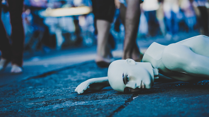 surface level, street, male, body part, representation, piggy bank, day, human foot, selective focus, focus on foreground, lying down, people, selective