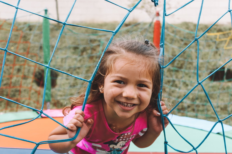 child, front view, facial expression, emotion, red, close-up, one person, dress, person, females, childhood, portrait, day, jungle gym, eyes, girl, real people