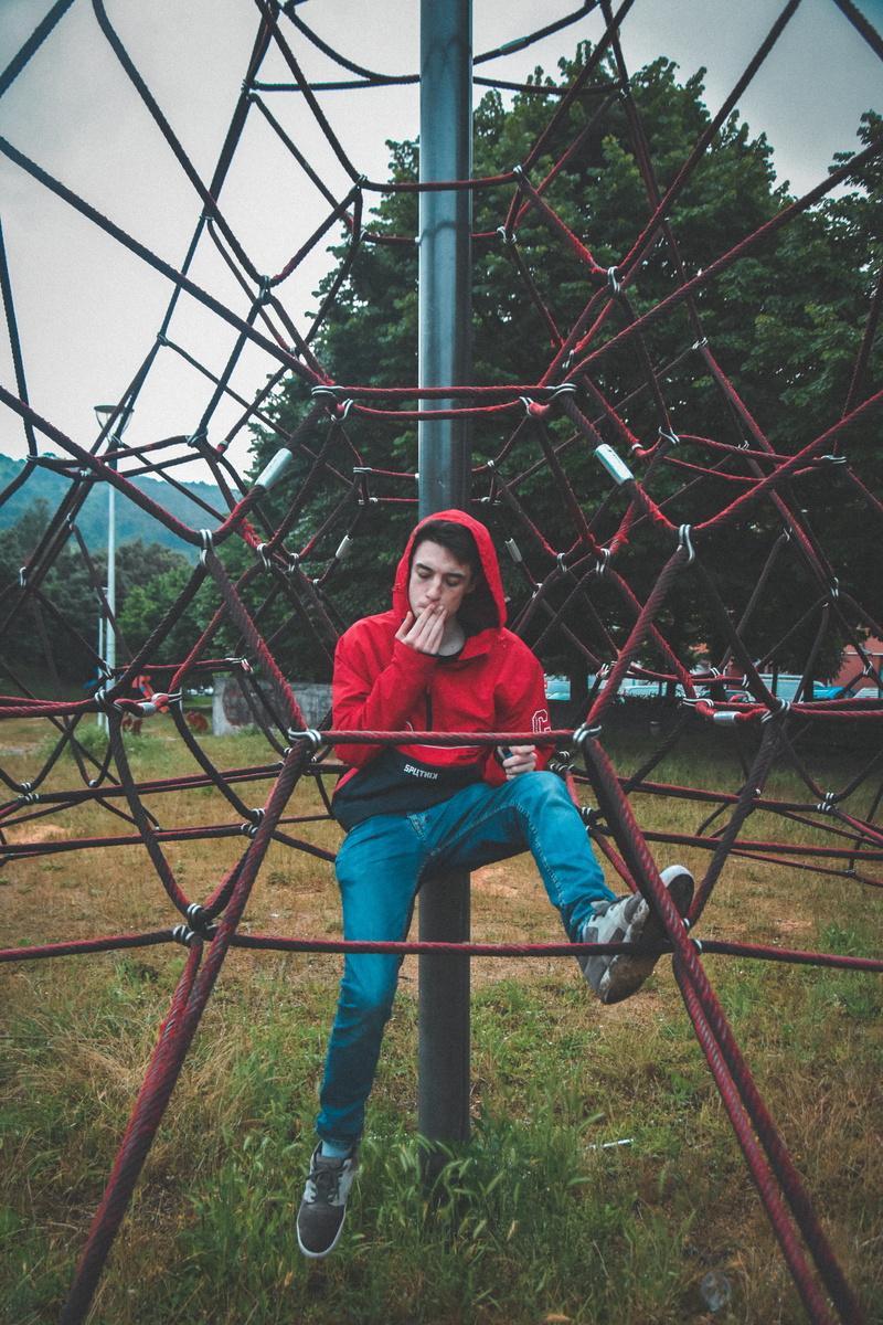 lifestyles, leisure activity, casual clothing, boy, playground, plant, full length, real people, spain, young adult, red, looking at camera, young women