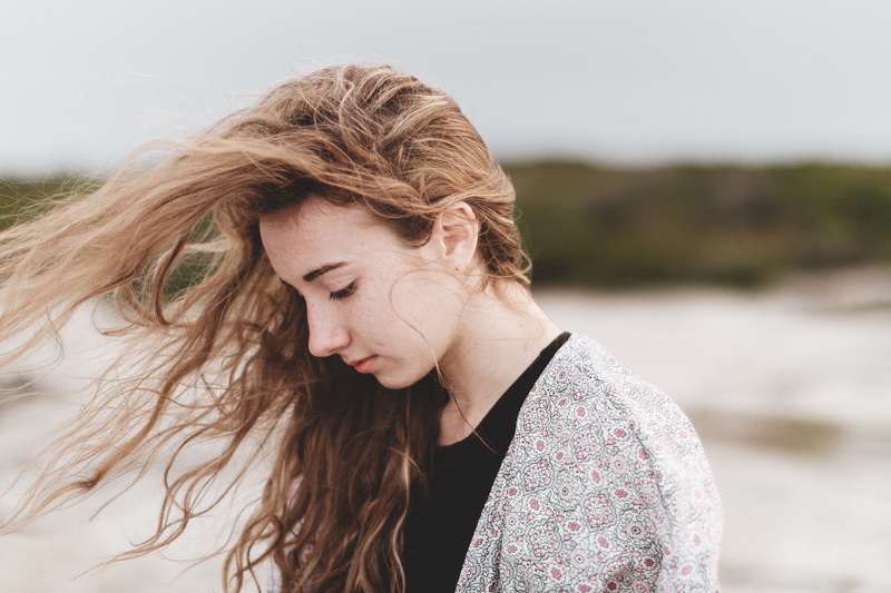 real people, young adult, one young woman only, contemplation, people, sad, cardigan, redhead, lifestyles, day, only women, hair, photography, looking down