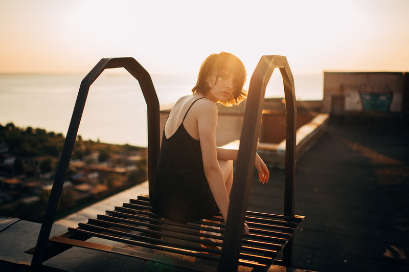 women, rooftops, 720P, brunette, looking at viewer, black dress, sitting, Marat Safin, women outdoors, sun rays