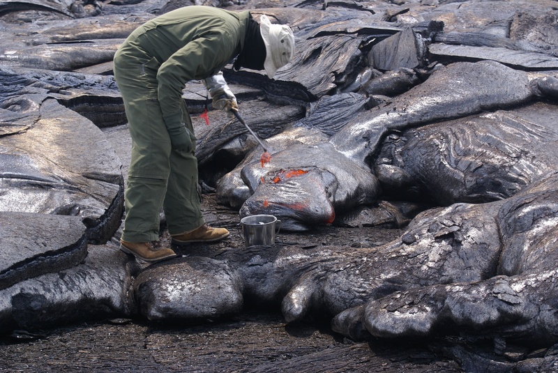 study, one person, occupation, working, flow, protective workwear, heat, sample, green, solid, bending, outdoors, full length, jumpsuit, lava, man, rock - object