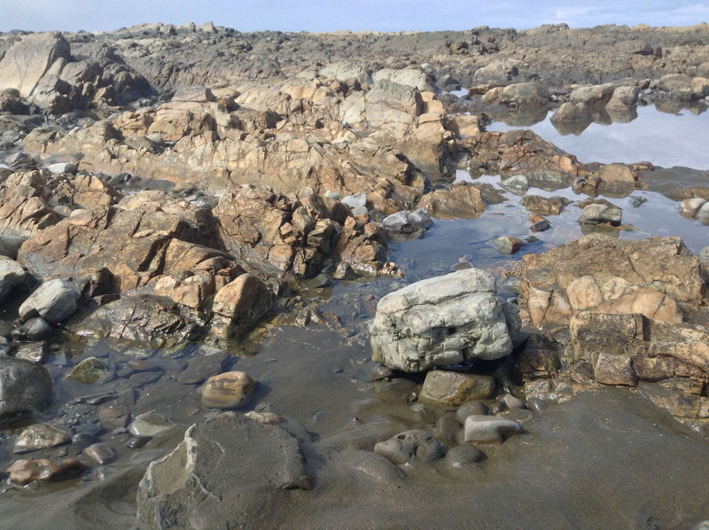 desert, blue sky, climate, rock, beach, arid climate, nature, non-urban scene, water, stones, rock - object, tranquility, rock formation, land, solid, rockyscape