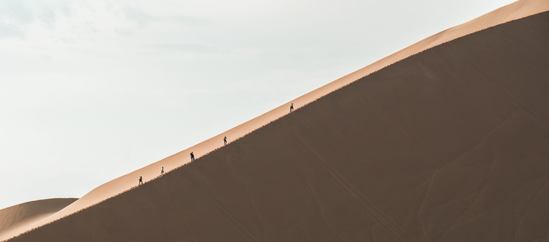 low angle view, sand, day, climbing, walking, hiking, building exterior, adventure, ridge, line, built structure, curve, wall - building feature, land