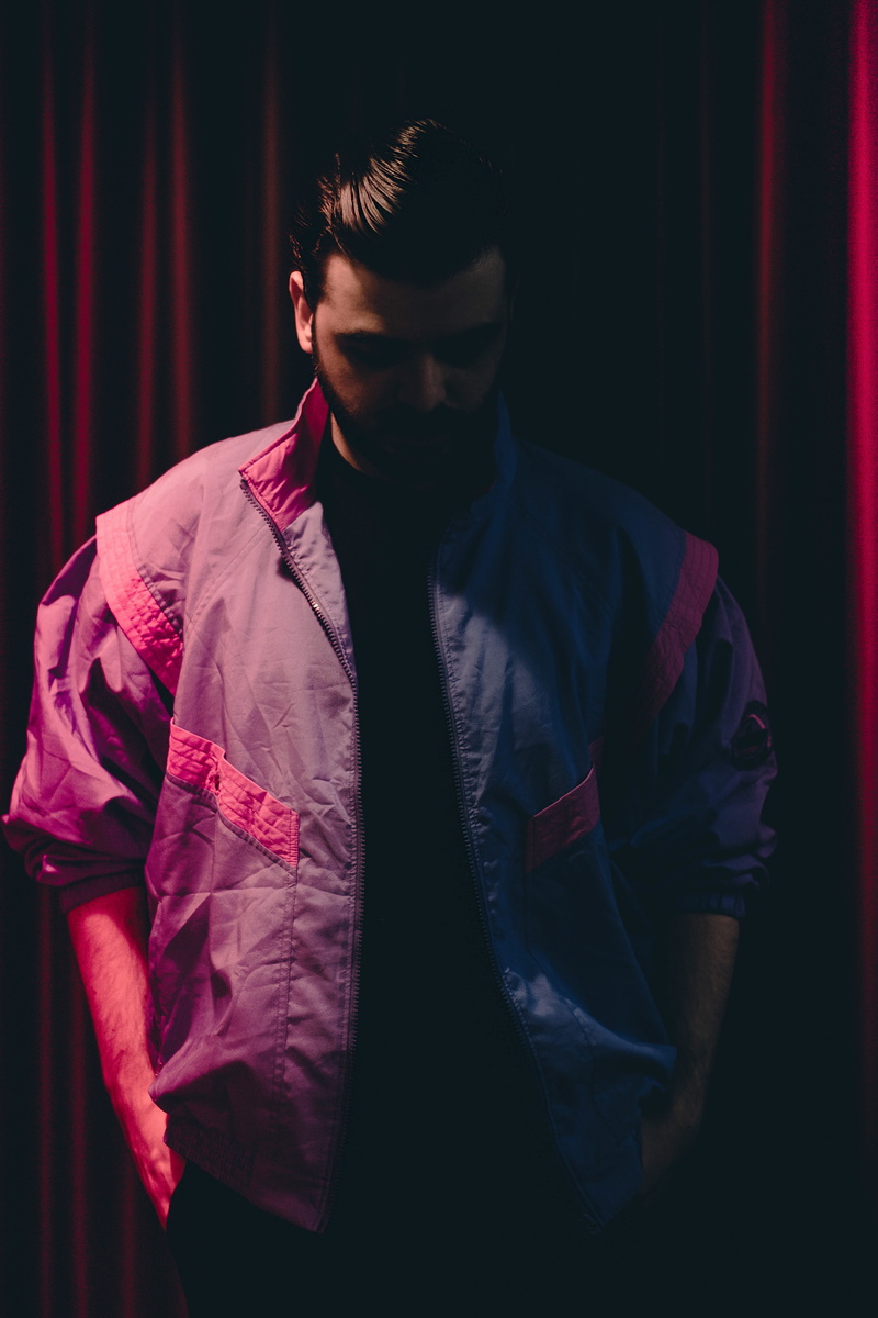 hands, textile, cyan, pouch, windbreaker, lifestyles, front view, red, male, looking, black background, moment, shadow, depression, dude, one person, style