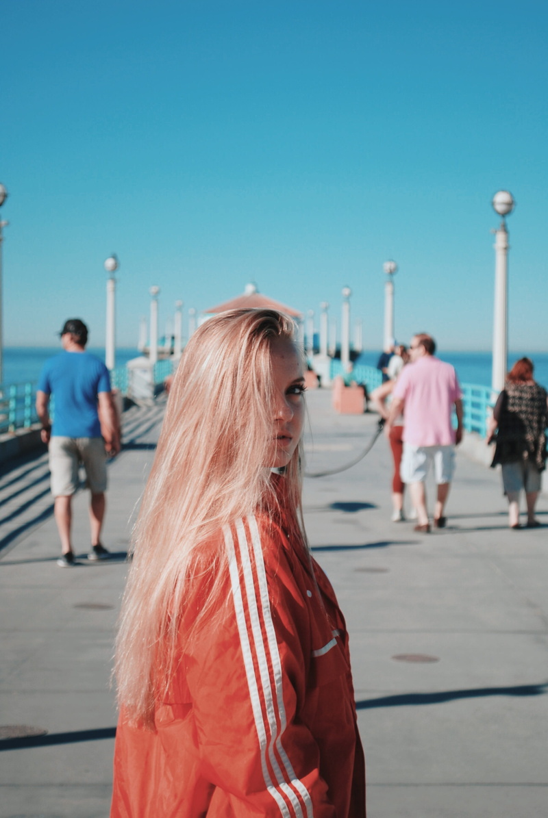 tourist, windbreaker, leisure activities, wearing, leisure activity, day, pink, building, running track, dock, focus on foreground, walking, pedestrian