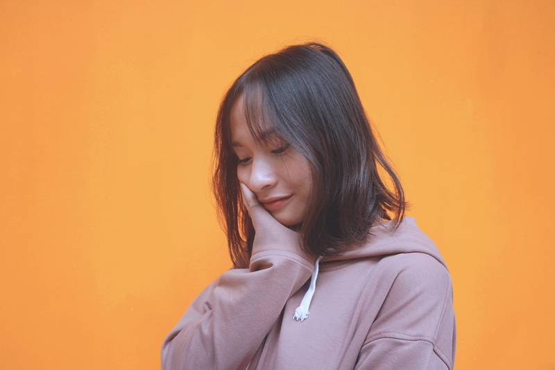 innocence, hairstyle, one person, child, friend, orange background, brown hair, hair, girls, studio shot, girl, headshot, vietnam, contemplation, emotion