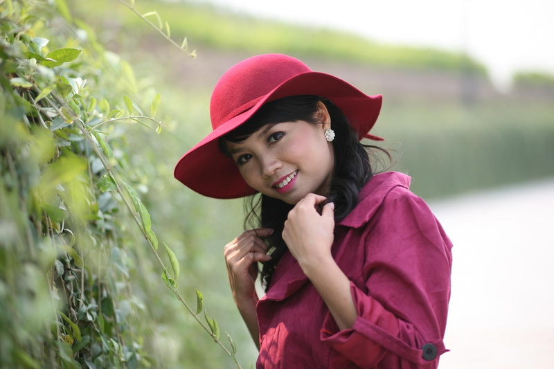 hairstyle, red skirt, waist up, clothing, nature, one person, portrait, women, woman, plant, young, smiling, vietnam, childhood, standing, innocence, costume