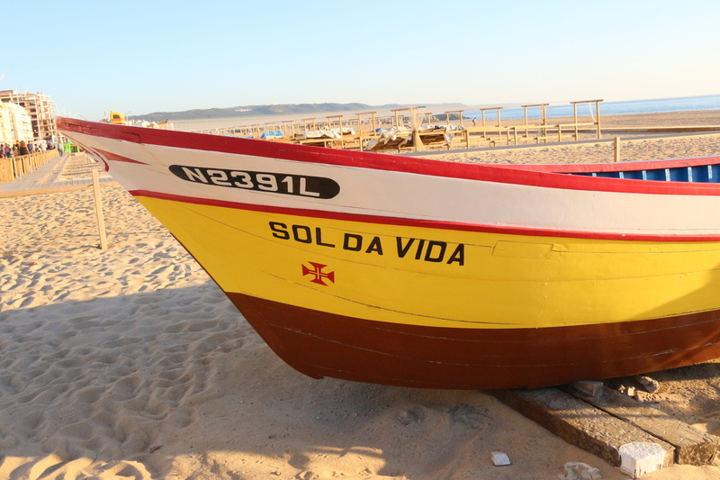 sun life, outdoors, holiday, day, beach, light, sand, sunlight, summer, water, land, mode of transportation, peace, nazareth, nature, moored, nautical vessel
