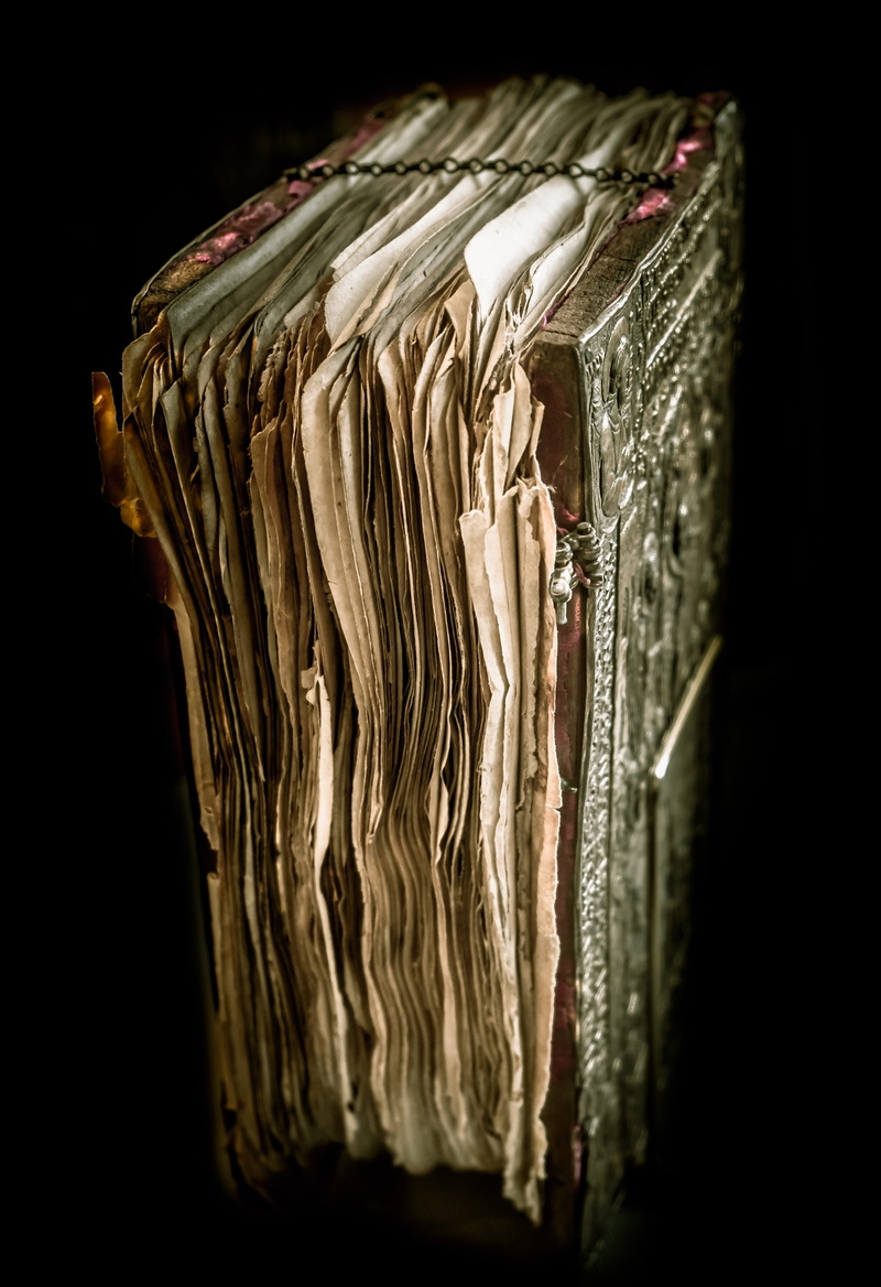 indoors, the past, ornate, the new testament, manuscript, book, black background, 4K, antique, selective focus, studio shot, focus on foreground, still life