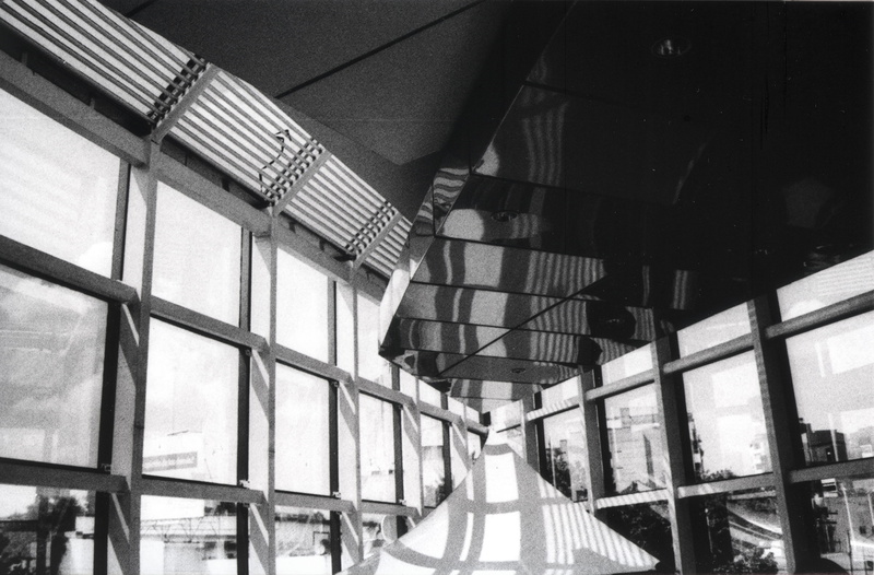 built structure, transportation, chair, photo, unam, window, glass - material, blackandwhite, day, handrail, mode of transportation, low angle view, sunlight