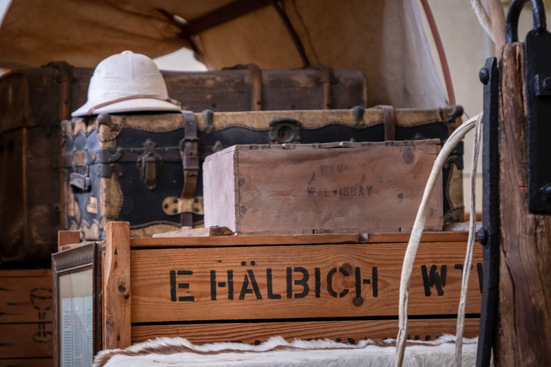 western script, sleeve, clothing, back, hat, sign, text, communication, non-western script, box, information, plywood, focus on foreground, no people, musical instrument