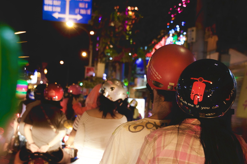 lifestyles, people, representation, human representation, focus on foreground, illuminated, group of people, street, vietnam, traffic, adult, building exterior