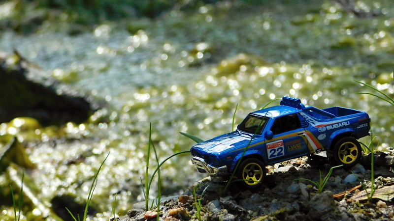 blue, toy car, toy, mode of transportation, outdoors, close-up, die cast, transportation, no people, scale model, 4K, diorama, growth, land vehicle, focus on foreground