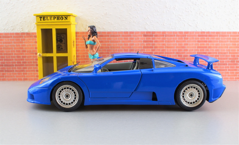 full length, day, Auto, sitting, vehicle, Bugatti, standing, side view, motor vehicle, model, young adult, sports car, car, toys, blue, architecture, woman