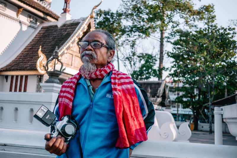 adult, jacket, men, mature adult, strap, waist up, 4K, scarf, electronics, front view, temple, street, people, leisure activity, video camera, gray, photographer