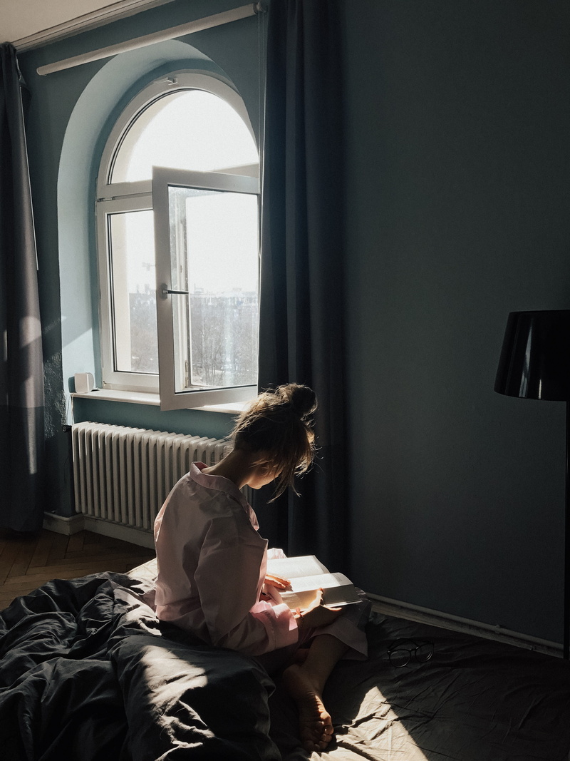 three quarter length, person, 4K, bedroom, indoors, home interior, sitting, leisure activity, one person, sunlight, lifestyles, reading, book, publication