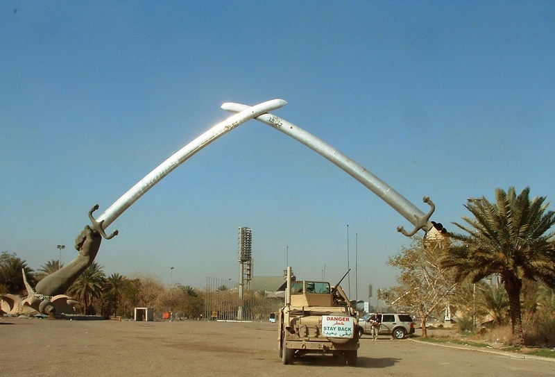 saddam, monument, sunlight, blue, tree, road, memorial, outdoors, arc, hands, car, truck, sky, land vehicle, triumph, nature, street, day, holding, baghdad