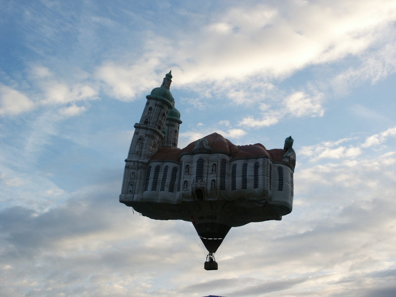 transportation, take off, captive balloon, building, spirituality, mode of transportation, hot air balloon, low angle view, military, built structure, outdoors
