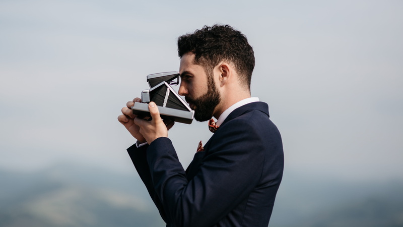 businessman, waist up, suit, people, outdoors, business, standing, looking, holding, man, caucasian Ethnicity, young Adult, polaroid, professional Occupation