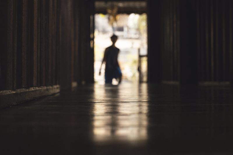 dark, light at the end of the tunnel, built structure, silhouette, corridor, passage, sunlight, door, beside, selective focus, indoors, wall, shadow, motion