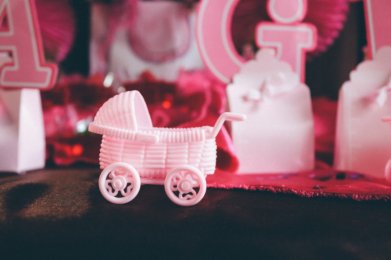 newborn, pink color, celebration, no people, indoors, joy, red, event, focus on foreground, cute, pavement, toy, representation, still life, stroller, brown