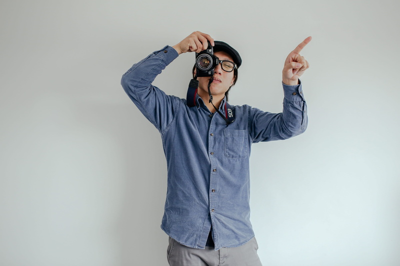 young adult, males, man, looking, wearing, person, accessory, dress shirt, home decor, gray, searching, blue, copy space, adult, finger, camera, standing