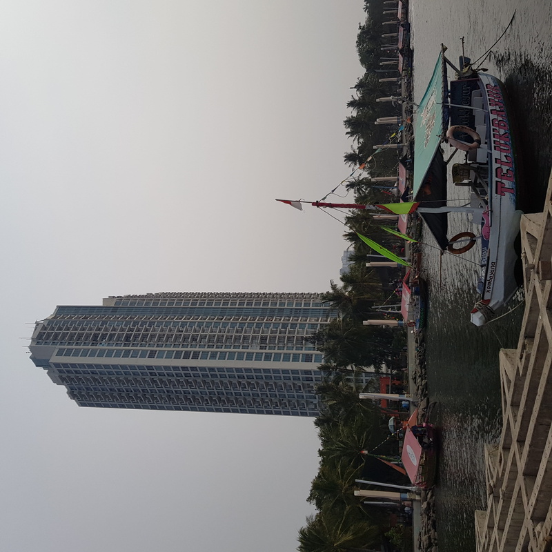 real people, skyscraper, group of people, occupation, low angle view, jakarta, tropical, spirituality, boat, ancol beach, seaside, java, day, people, dock