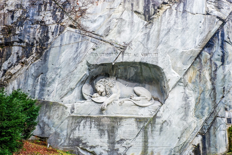 outdoors, sculpture, day, rock, lucerne, craft, built structure, human representation, male likeness, rock formation, lion monument, representation, switzerland