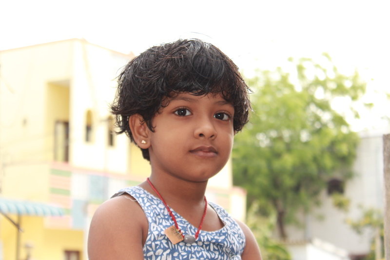 looking at camera, lifestyles, outdoors, front view, child, real people, girls, street, hairstyle, innocence, casual clothing, day, indian girl, portrait