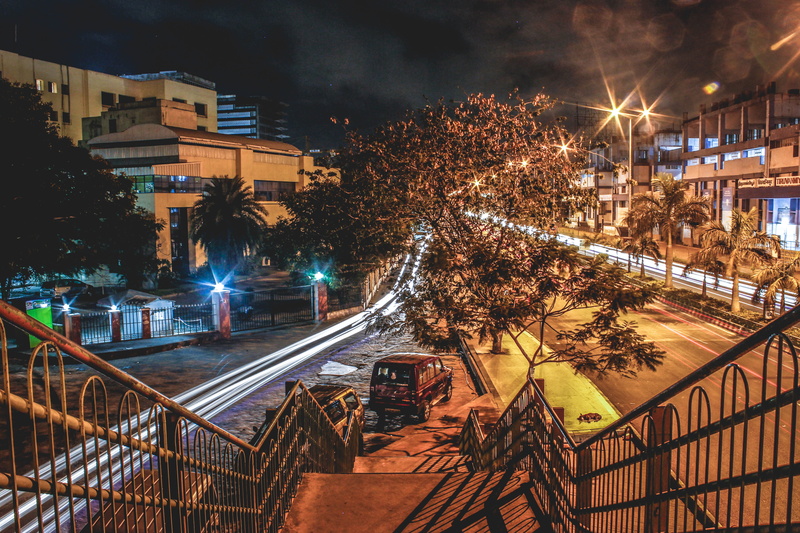 city, building, city street, pavement, built structure, lights, night, stairs, tree, road, illuminated, residential district, canal, no people, transportation