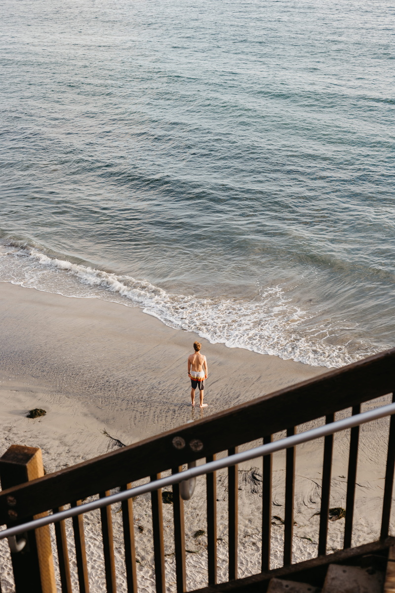 person, leisure activity, real people, promontory, 5K, human, one person, beauty in nature, day, transportation, beach, standing, man, seashore, sea, railing