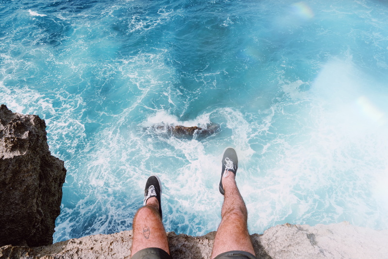 tourist, mountain, men, tourism, outdoors, ocean, cliff, foot, sneaker, nature, landscape, sitting, scenics, coastline, shoe, summer, beach, bright, blue