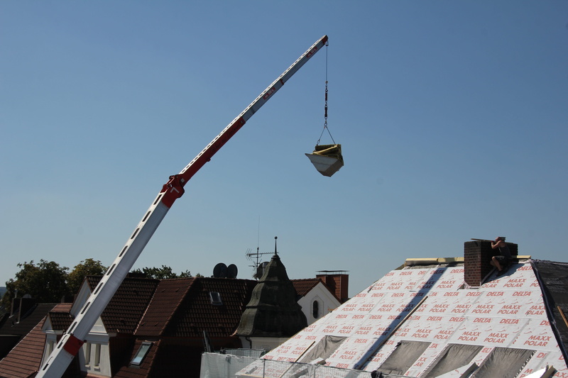 construction work, low angle view, outdoors, lighting equipment, roofers, crane, clear sky, blue, roof, work, craftsmen, construction, roofing work, residential district