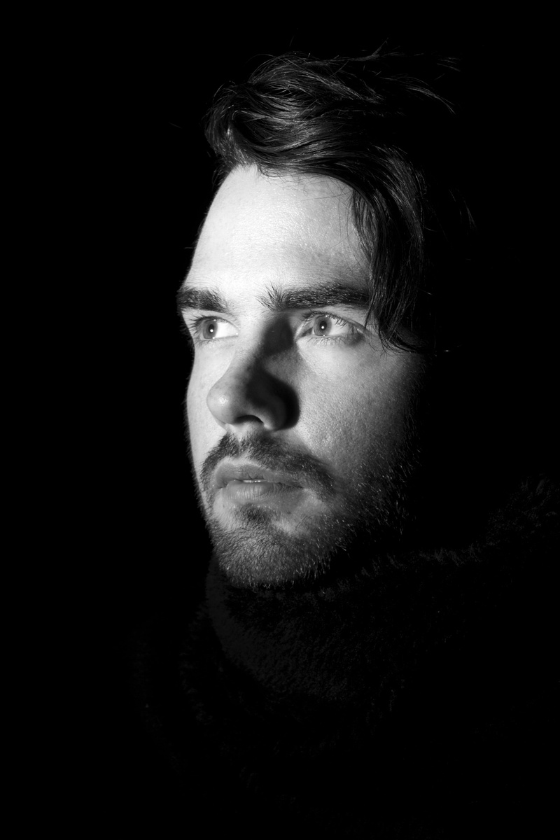 real people, one person, lifestyles, warm clothing, beard, headshot, human face, studio shot, man, looking away, only men, portrait, light, contemplation